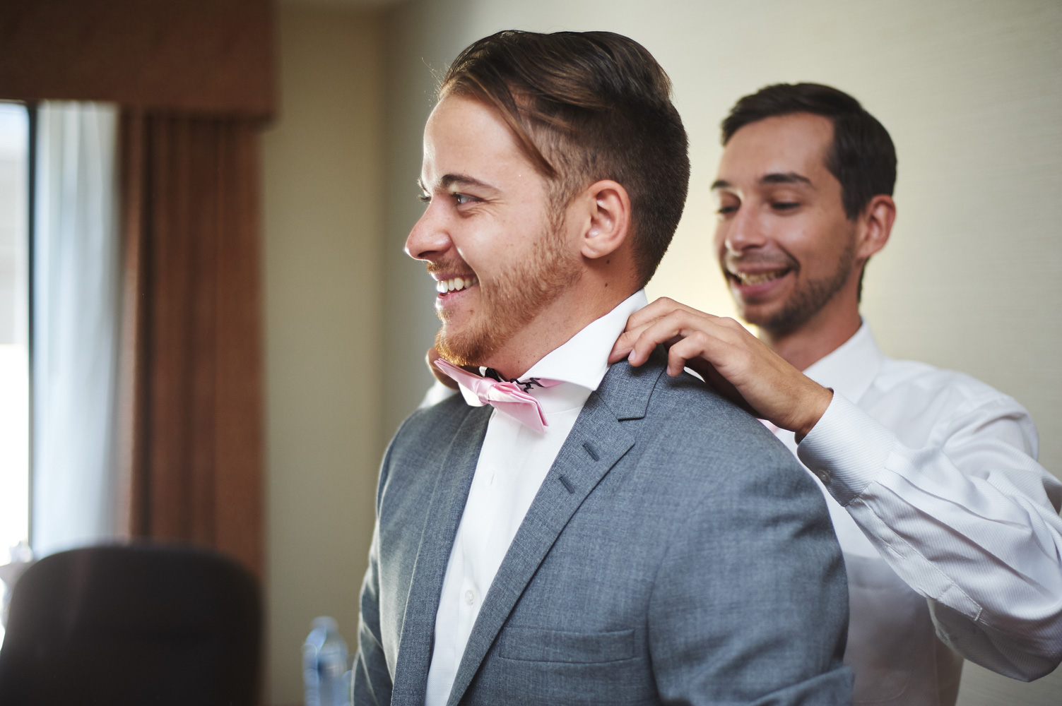 groom-having-his-collar-adjusted-by-a-groomsman.jpg