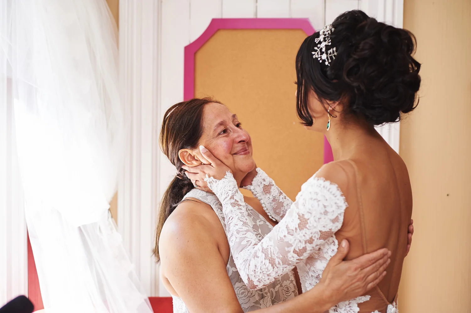Mother-of-the-bride-helping-her-daughter-on-her-wedding-day.jpg