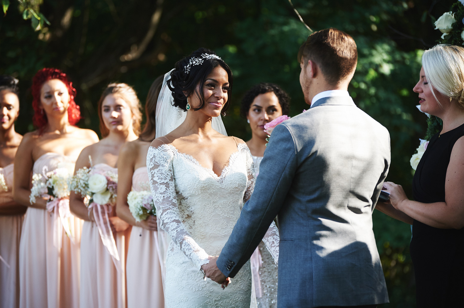 bride-and-groom-reading-their-vows-to-eachother-in-an-outdoor-ceremony.jpg