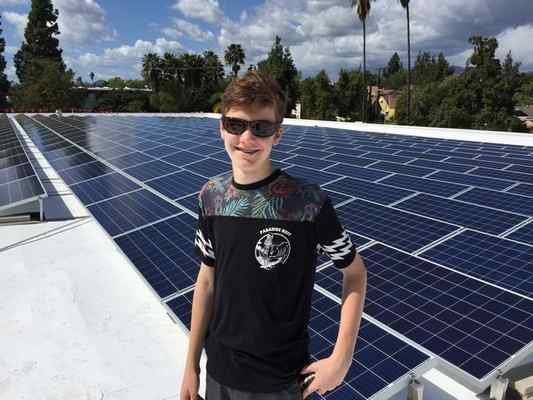 Brett Barnard has 744 solar panels on the roofs on his two Pasadena businesses - STORBOX Self Storage business and The Wine Grotto. It’s the largest non-institutional photovoltaic solar array in the city. His 14-year-old son Cole is shown here in front of some of the panels.