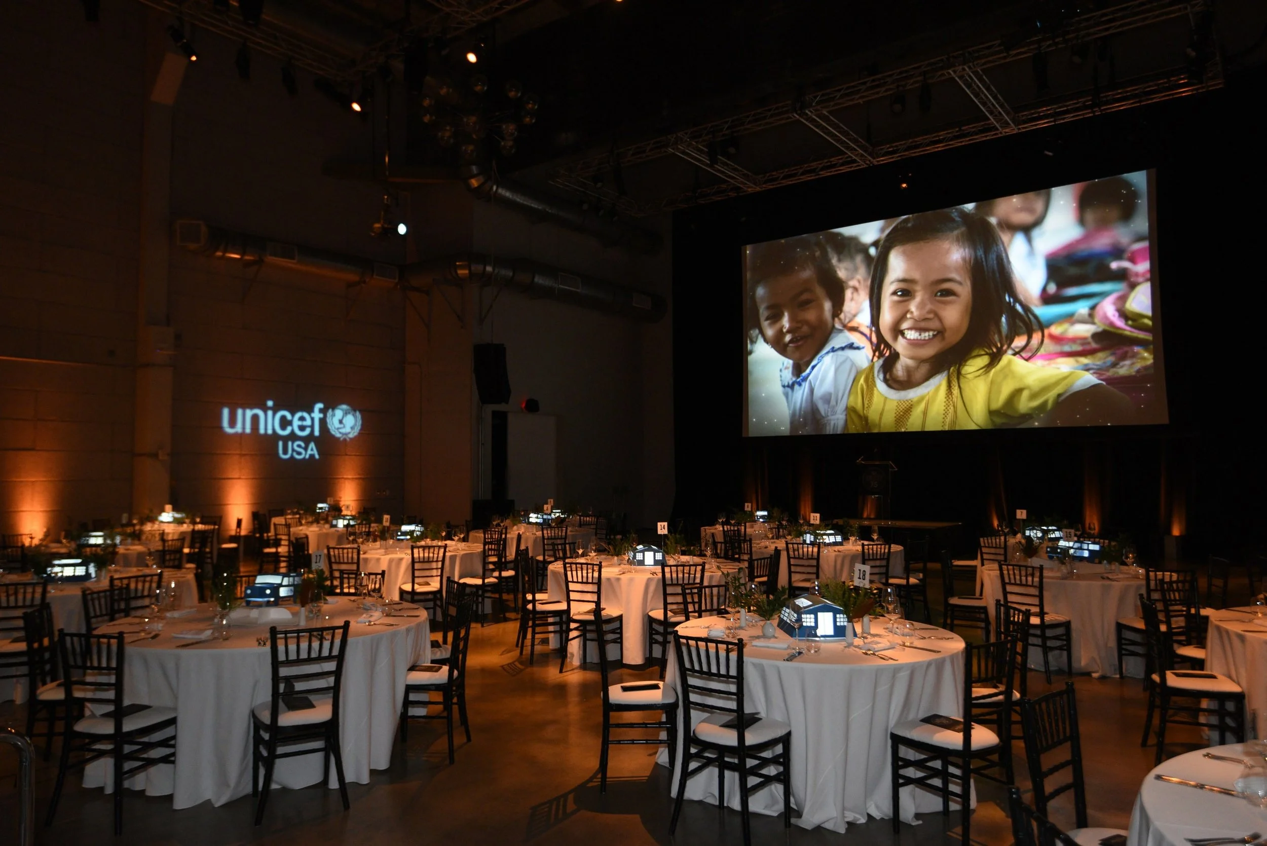   UNICEF’S 75TH ANNIVERSARY CELEBRATION   Pop-up centerpieces: tents, trucks, and pumps 