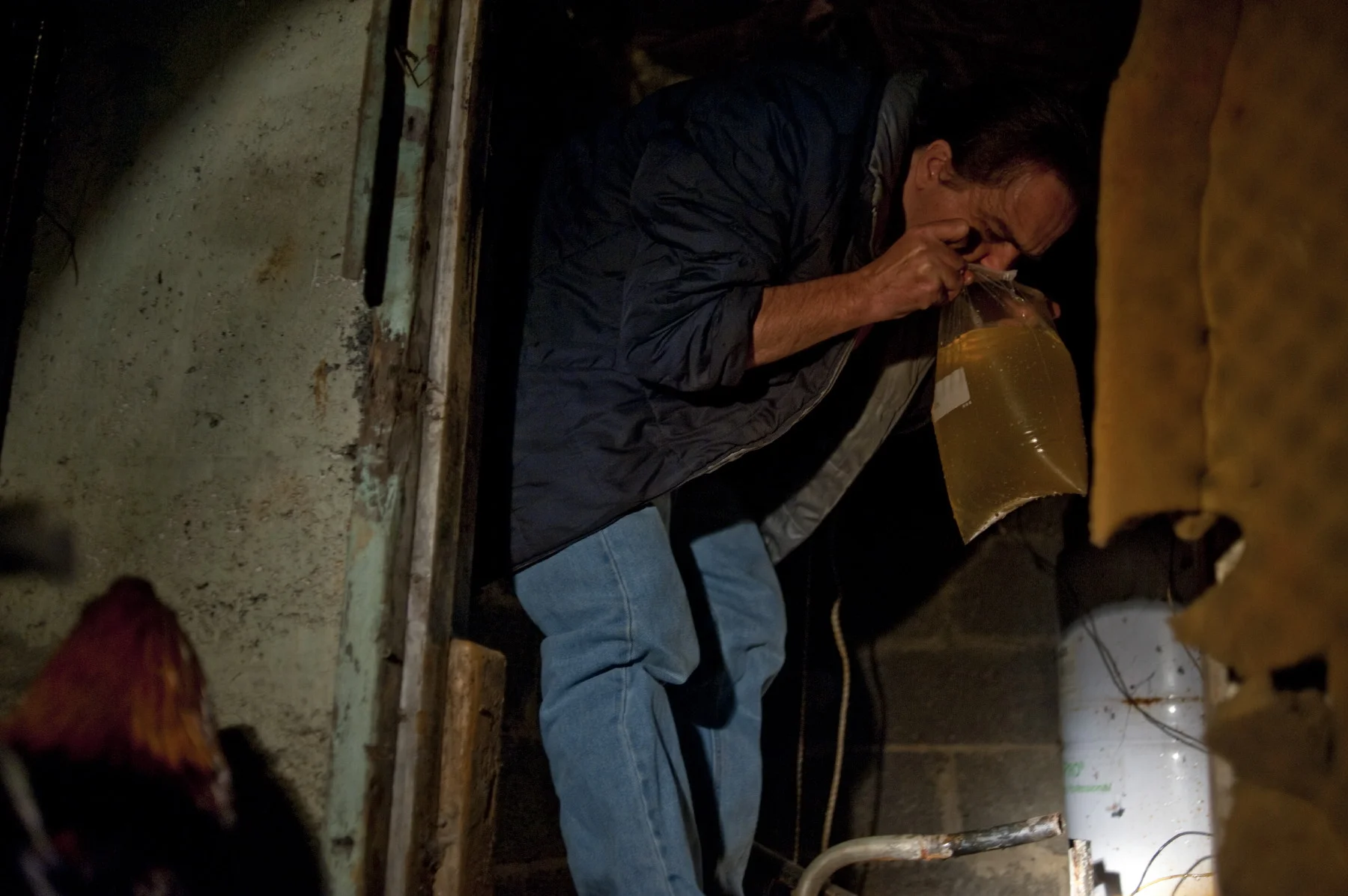  Rawl WV (USA), September 2010 - A men smelling the odor out of well water. For decades, coal companies in Appalachia have injected slurry into worked-out mines as a cheap alternative to dams and other systems that can safely store or treat it.  The 