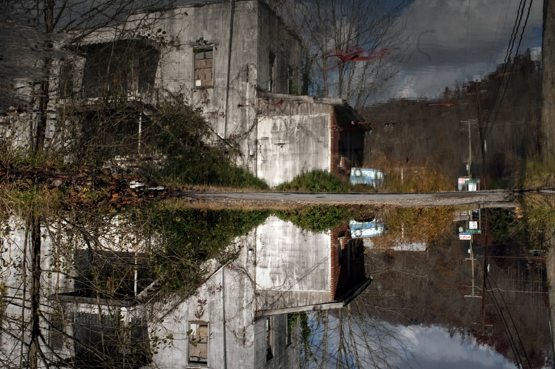  Naoma. Water reflection of an abandoned building. Depopulation is very strong in the Coal Fields where the only job often available is with the coal operators who eventually move elsewhere when the coal runs out. Several bankrupt abruptly this way. 