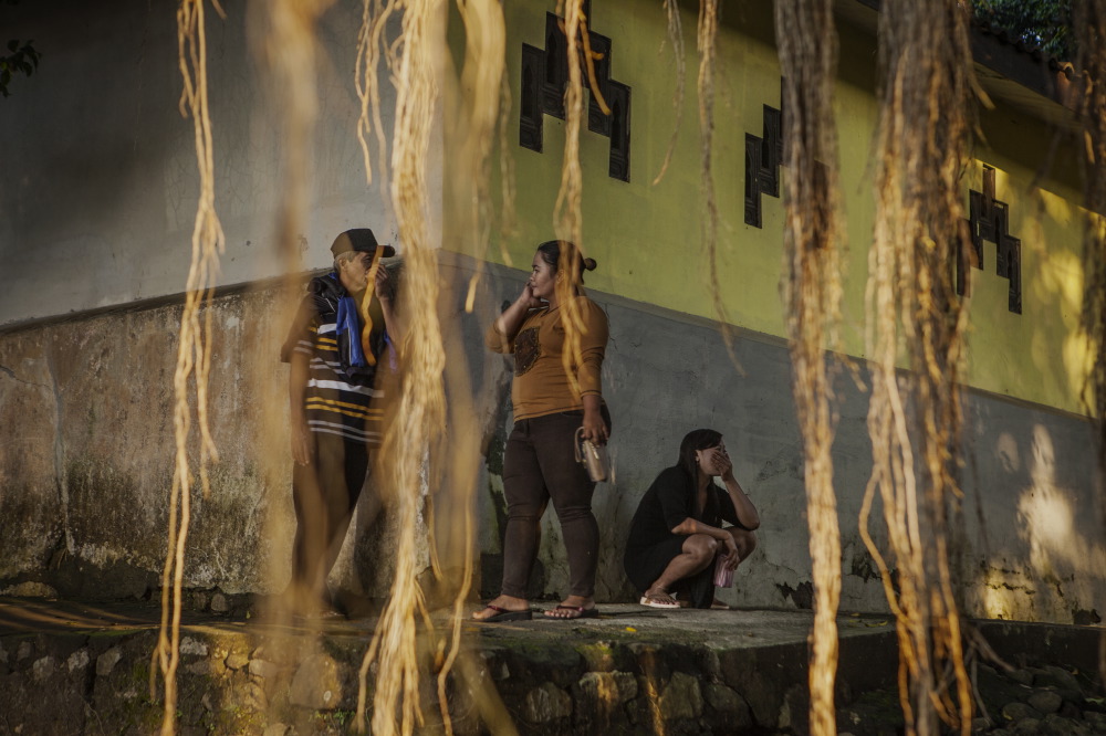 Prostitutes wait for clients outside the shrine.