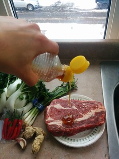Season your steak with sesame oil and salt and pepper, oil the steak. Not the pan. It will stick less.