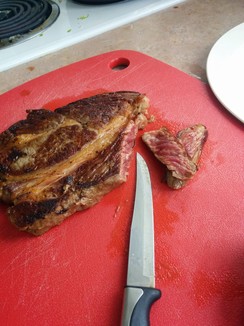 NOM! Cook with the fat, discard the fat when serving. This is a piece of grass-fed beef, so it's a little on the fatty side (cause I am cheap and bought a cheaper yet fancier cut.) I suggest going with a striploin or flank cut instead.