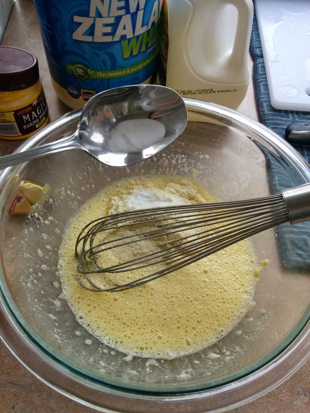 Beat egg and egg white until frothy. Add protein powder. Whisk until smooth. Add coconut flour, mix until smooth and then add leavening agents (baking powder and soda.)