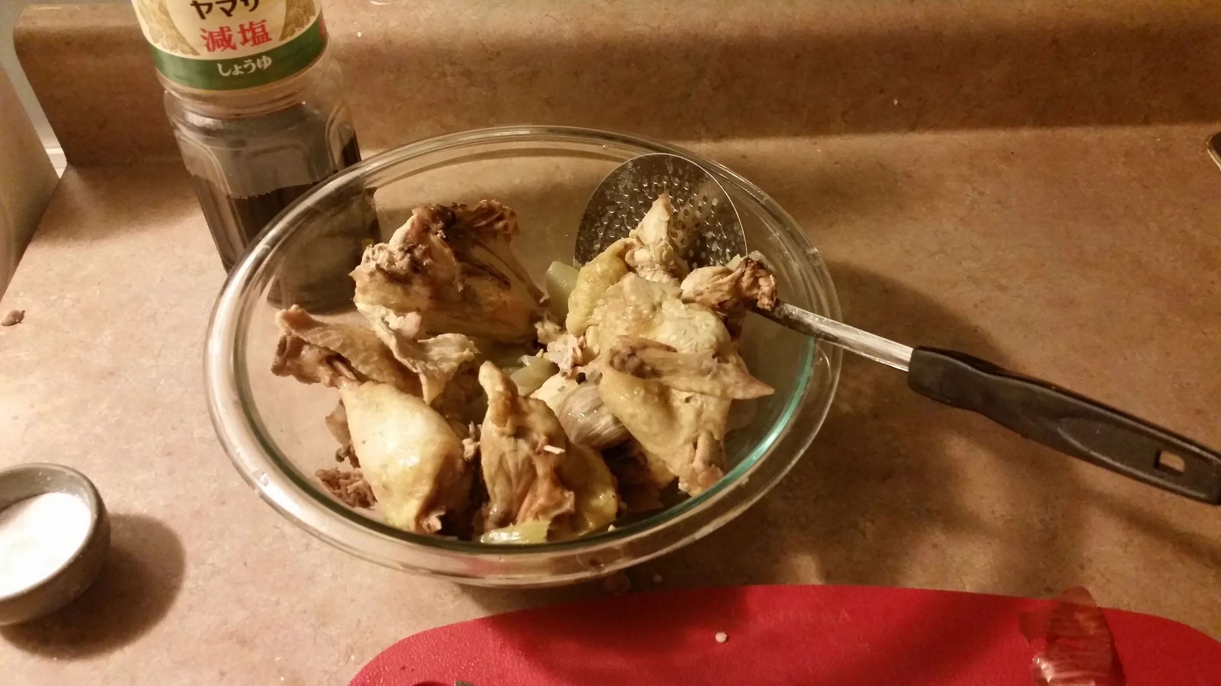 Once the chicken is cooked (anywhere from 45 minutes to 1.5 hrs) reserve cooked chicken to a bowl. Season the broth with soy sauce and strain out the vegetables.
