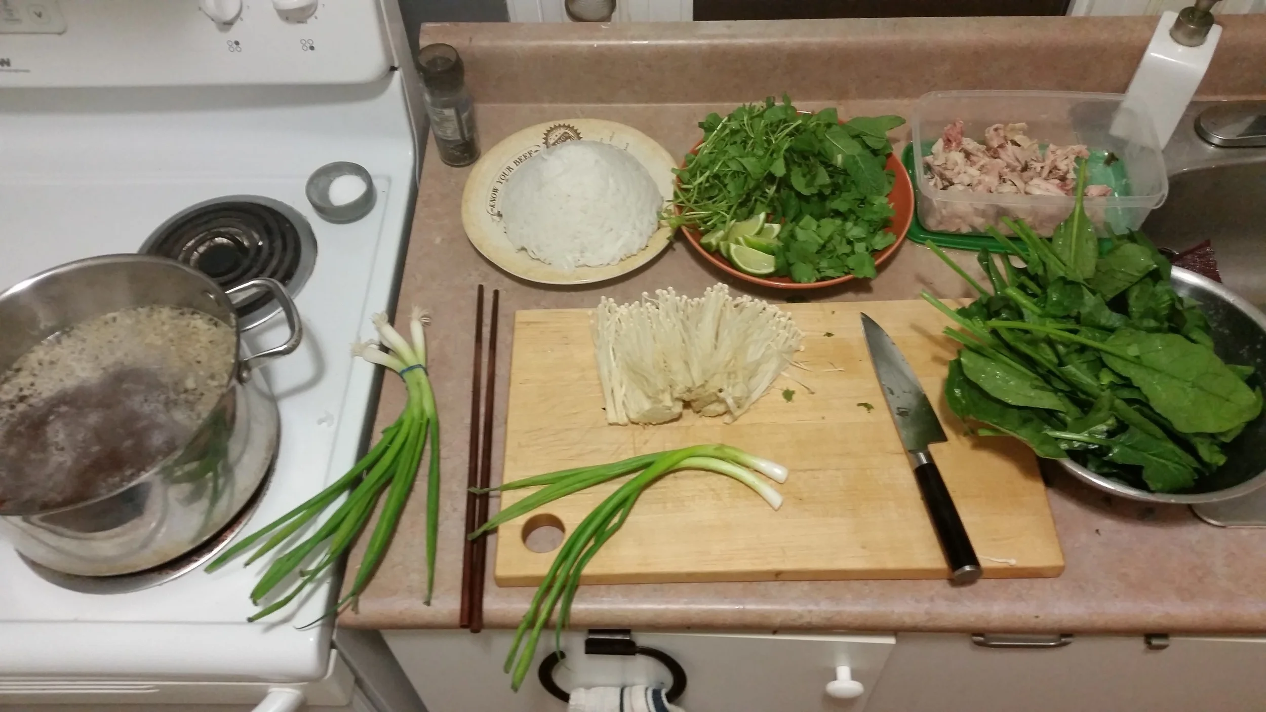 Reheat the broth, boil some rice noodles, pick the chicken off the bones, wash some greens and you're about to have yourself a great time. This is just one option of what can be done with a good home made soup broth. Pictured: enoki mushrooms, spinach, mint, watercress, cilantro, green onions, lime wedges and rice noodles.