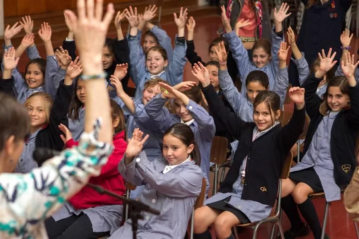 Priscilla and students doing Shaking Hands