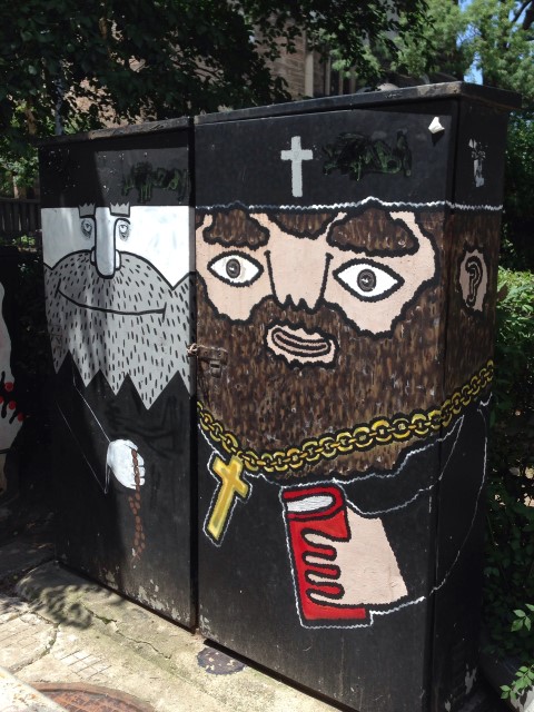  In my neighborhood, there were lots of utility boxes painted with characters and scenes. This is just outside a church. 