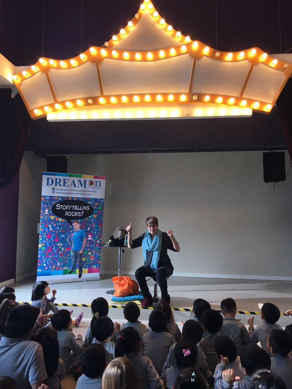 On my last day, I performed at a preschool, in a cute little theater. Notice my booties? They take great care of the floors, so kids wear only-indoor shoes and guests don these maroon lovelies.