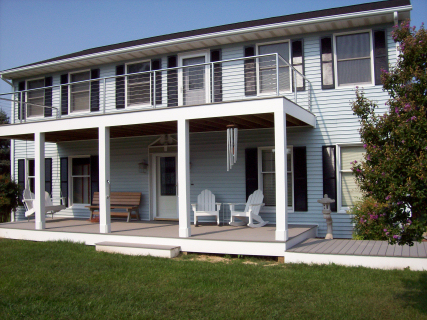   This home had a second floor deck added. They liked it so much they had Carrion Home Repair add another on the opposite side of the house. These decks are framed with pressure treated 2x10's. The decking is gray evergrain (5/4 x 6in). The decking a