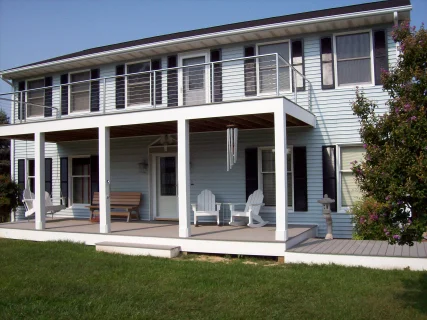 This home had a second floor deck added. They liked it so much they had Carrion Home Repair add another on the opposite side of the house. These decks are framed with pressure treated 2x10's. The decking is gray evergrain (5/4 x 6in). The decking and columns are wrapped with "Azek". A window was removed and an exterior door and Pella storm door was added.