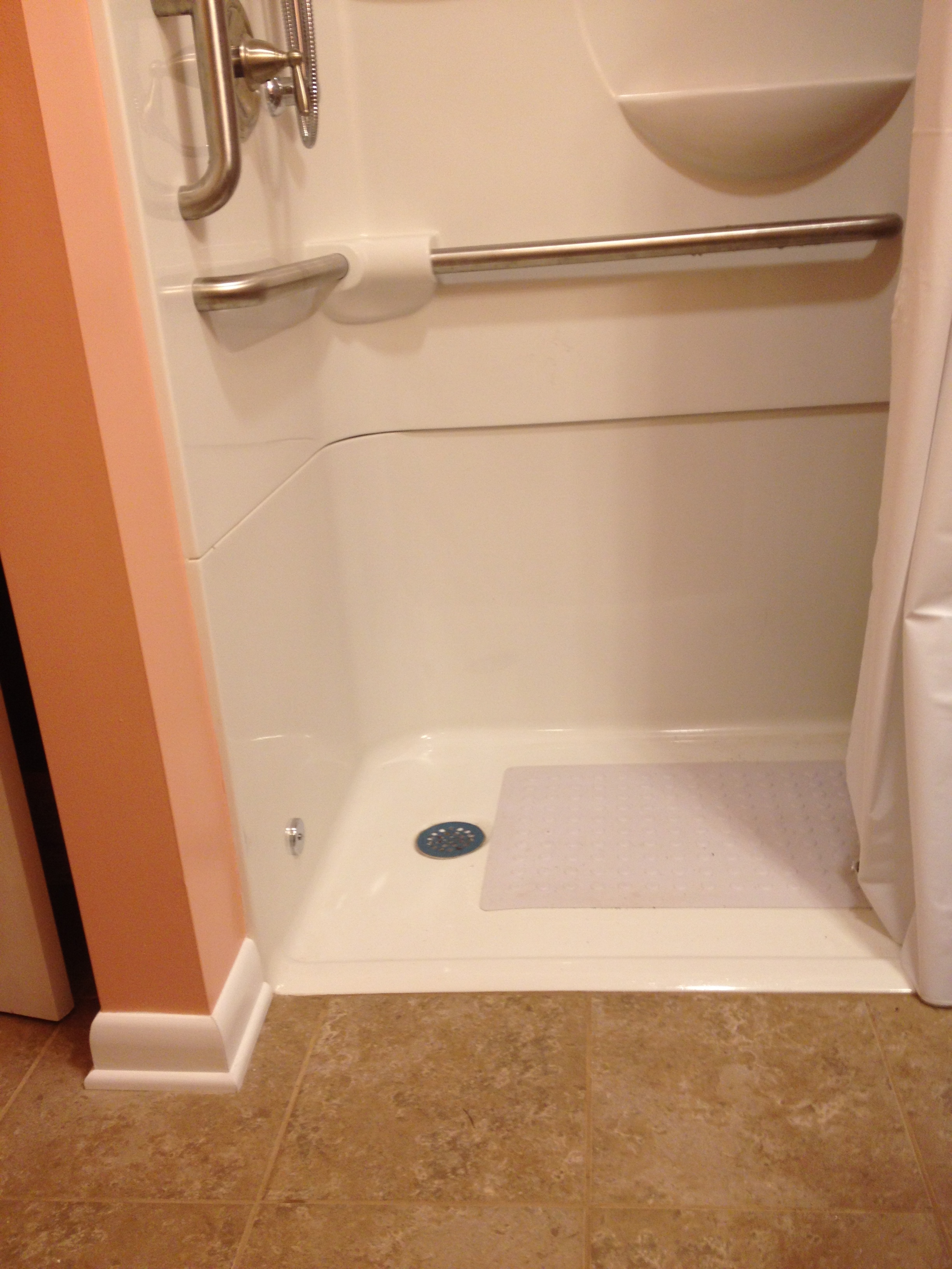  Bathroom with a handicap shower and a threshold that is less then an inch high 