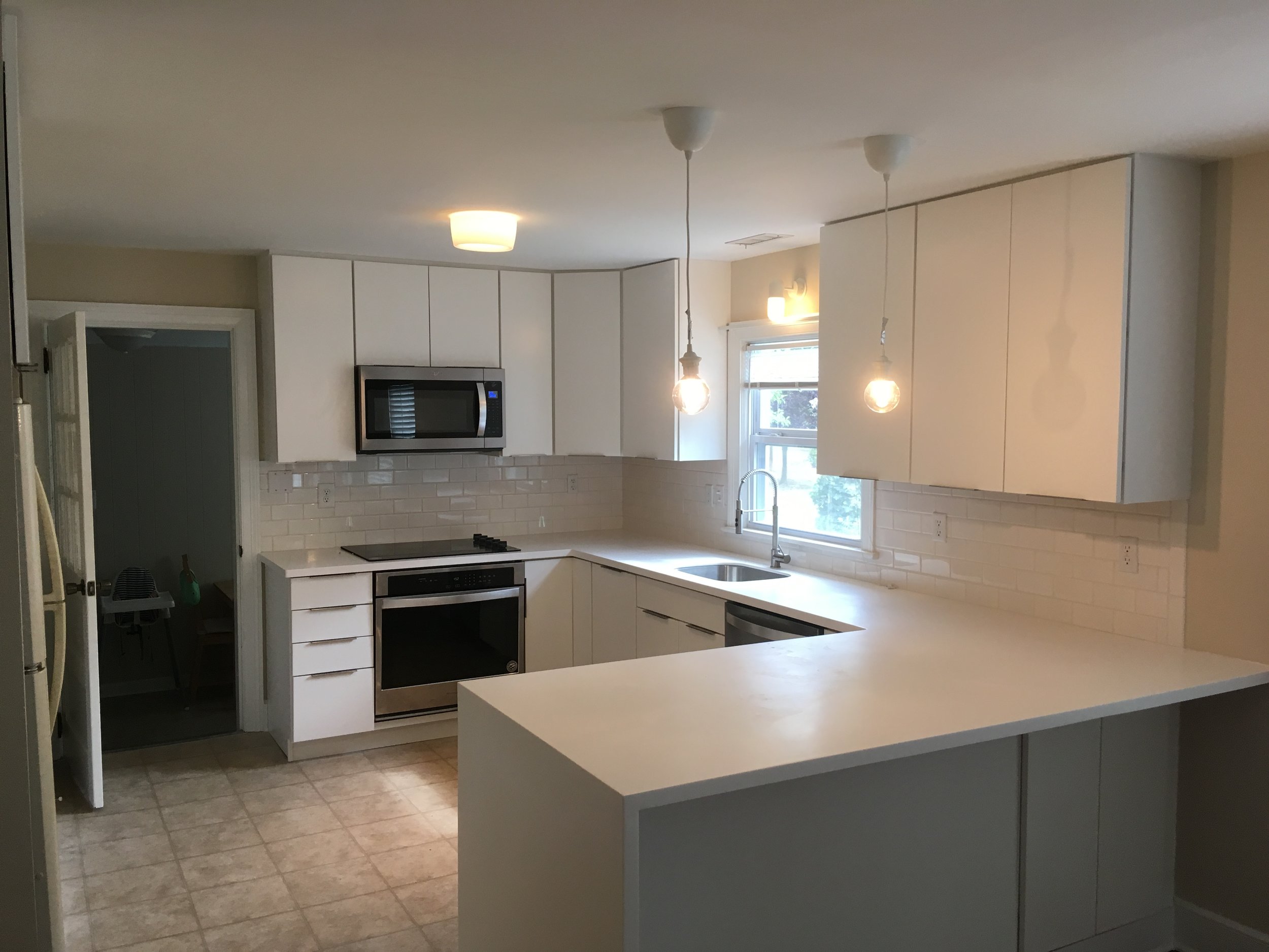  This new kitchen is complete with new Waypoint cabinets and Glacier white corian waterfall countertops. 