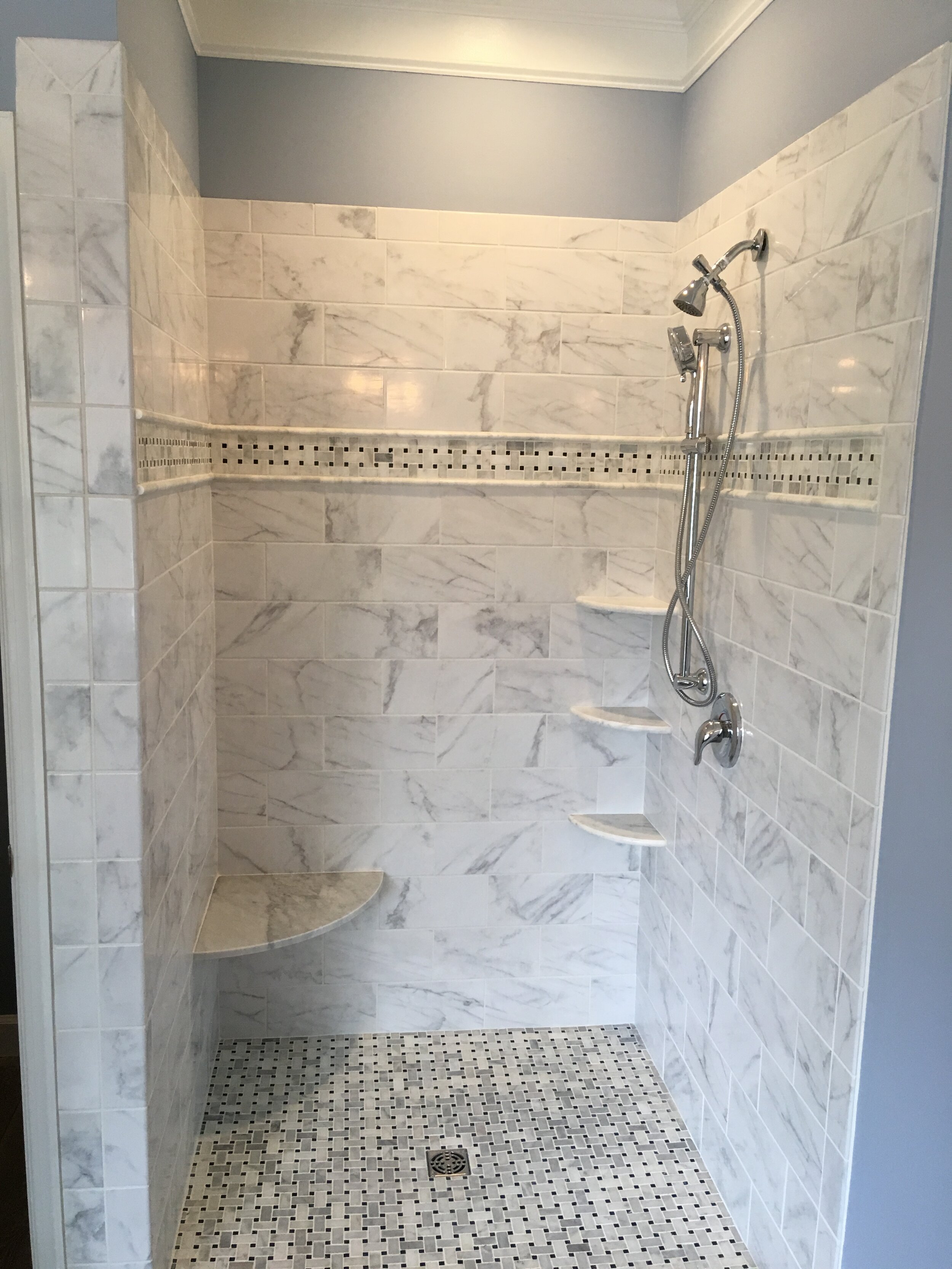  We recently finished this shower that has the Schluter system for tile, Classic Carrara tile soap shelves and seat with the Carrara basket weave accent tile. 
