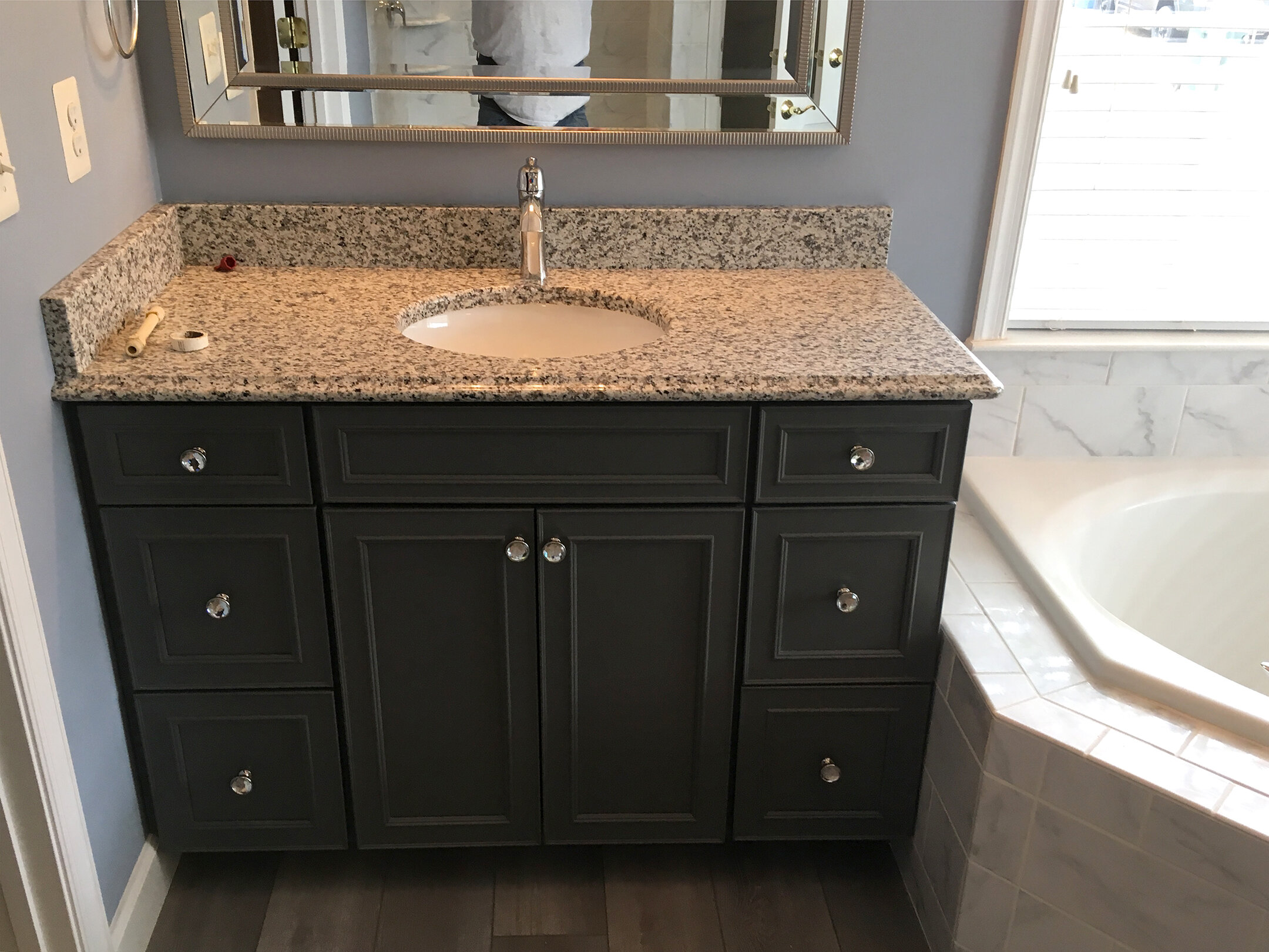  This cabinet is finished with a Luna Pearl granite countertop. 