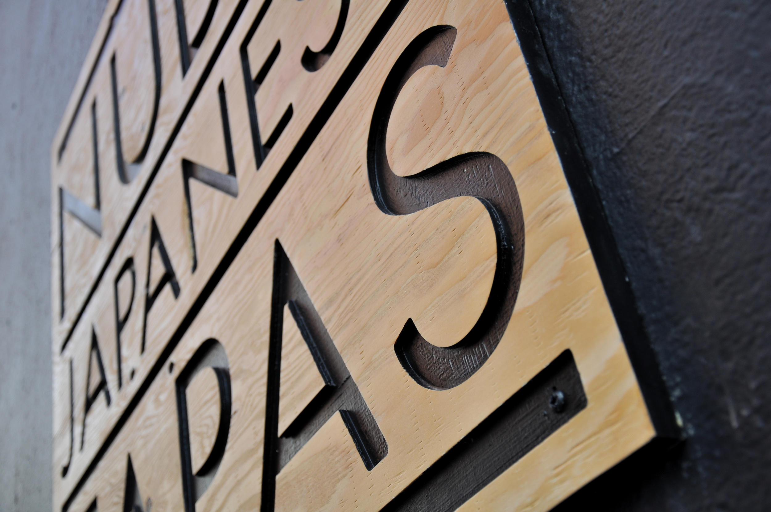  Standard plywood was cut using a CNC router, then painted and sealed. These signs are a welcoming preview of the modern aesthetic that continues inside the restaurant. 