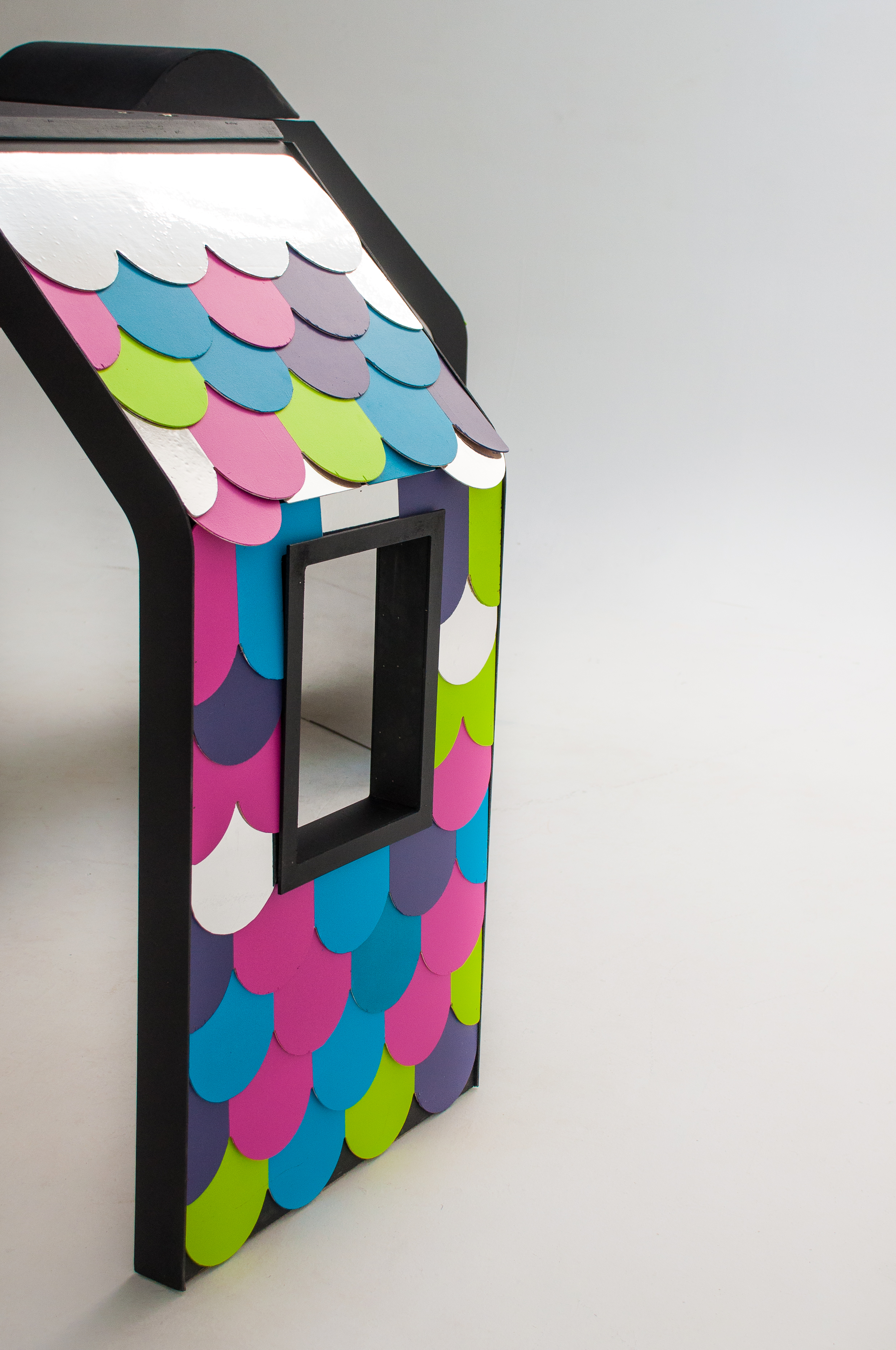  The resulting playhouse, clad in brand-coloured shingles and containing mirrored and magnetic interior surfaces, was designed and fabricated for maximum portability and super quick set-up &amp; tear-down. 