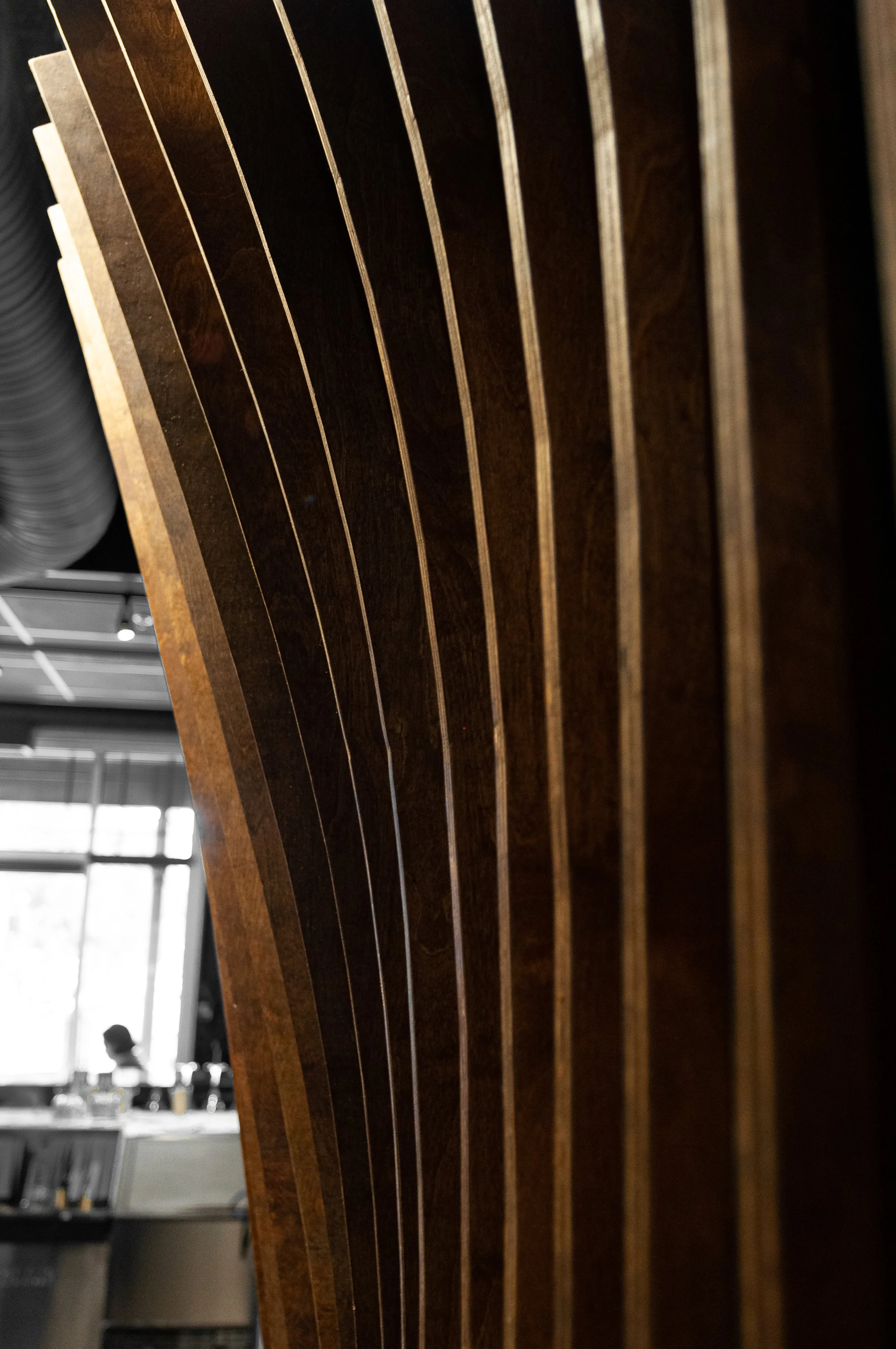 The hallway installation is composed of incrementally differing fins, which are rotated to emphasize the shape and density of the form.