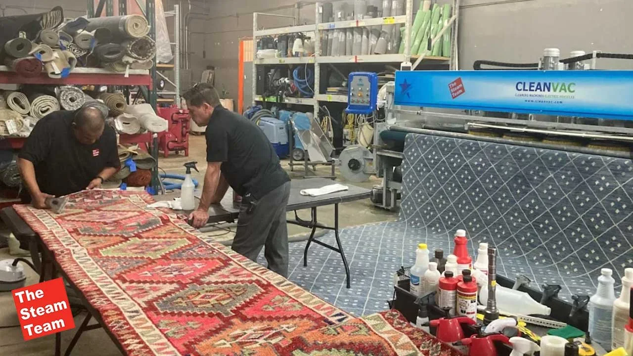 Two Steam Team Crew repairing a rug