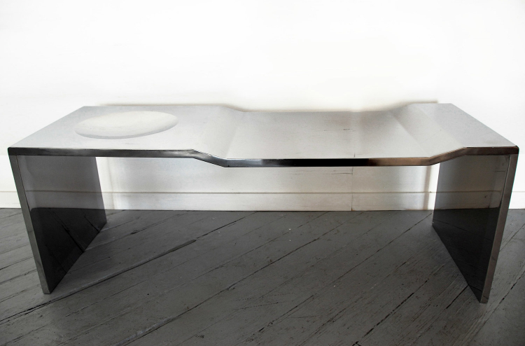2009 Stainless steel 15-7/10 x 50 x 15-7/10 in (40 x 127 x 40cm) Bowl Bench Stainless Steel is the metallic version of the hand- sculpted plywood series. Nature morte bowl series is an homage to the artist’s grandmother Anita, who always had a porcelain bowl with porcelain fruit decorating the dinning table. Errazuriz’s parents and uncles continued the tradition, and so in an attempt to invite his generation to incorporate this tradition, the artist decided to physically carve out a bowl into the surface of his table. The table itself is also carved out of plywood blocks.