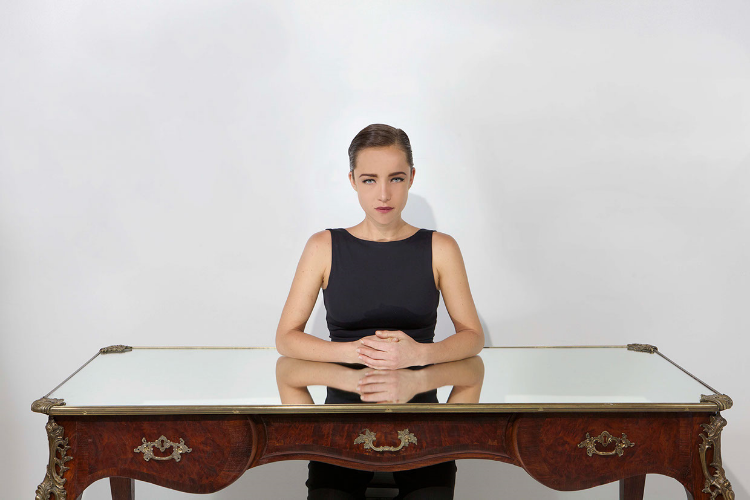 “I love the way the user now enters right into the cut we created in the desk. His body is reflected like a queen of hearts on a playing card. Surrounded by your self; the viewer is suddenly, very aware of himself,” explains the artist. “The photographs we took of the girl sitting at The Narcissus Desk reminds me of “Noire et blanche” by Man Ray. He has always been a big influence; I’m sure the image of the girl next to the mask was wedged in my unconscious somewhere.”