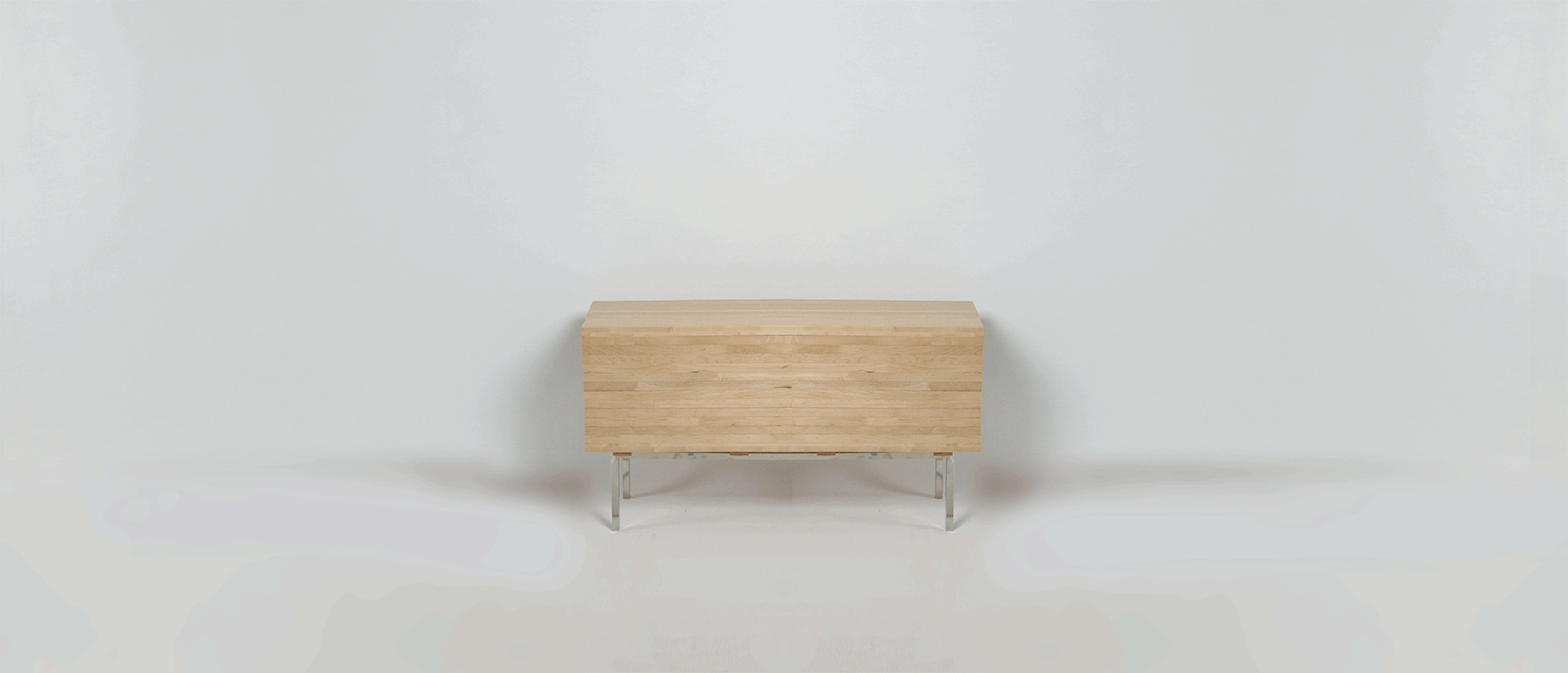 2014 Maple, Glass, and Stainless Steel 29 1/4 x 56 x 15 7/8 in. (74.30 x 142.24 x 40.48 cm) The Explosion Cabinet is a new sculptural furniture that challenges the paradigm of Cabinet conception. Inactivated, Explosion sits as a tidy, beautiful credenza. Transparent glass sidewalls provide a glimpse inside this intriguing but staid box. Further exploration of the central vertical seam reveals an entirely different object: With a gentle push, the rails slide further and further open until it seems that the cabinet has exploded beyond the bounds of stability. Even as Explosion’s exterior expands outward, it retains beautiful geometric proportions, using mechanics so complex that they took more than a year to perfect, despite borrowing one of cabinetmaking’s oldest tricks, the sliding dovetail.
