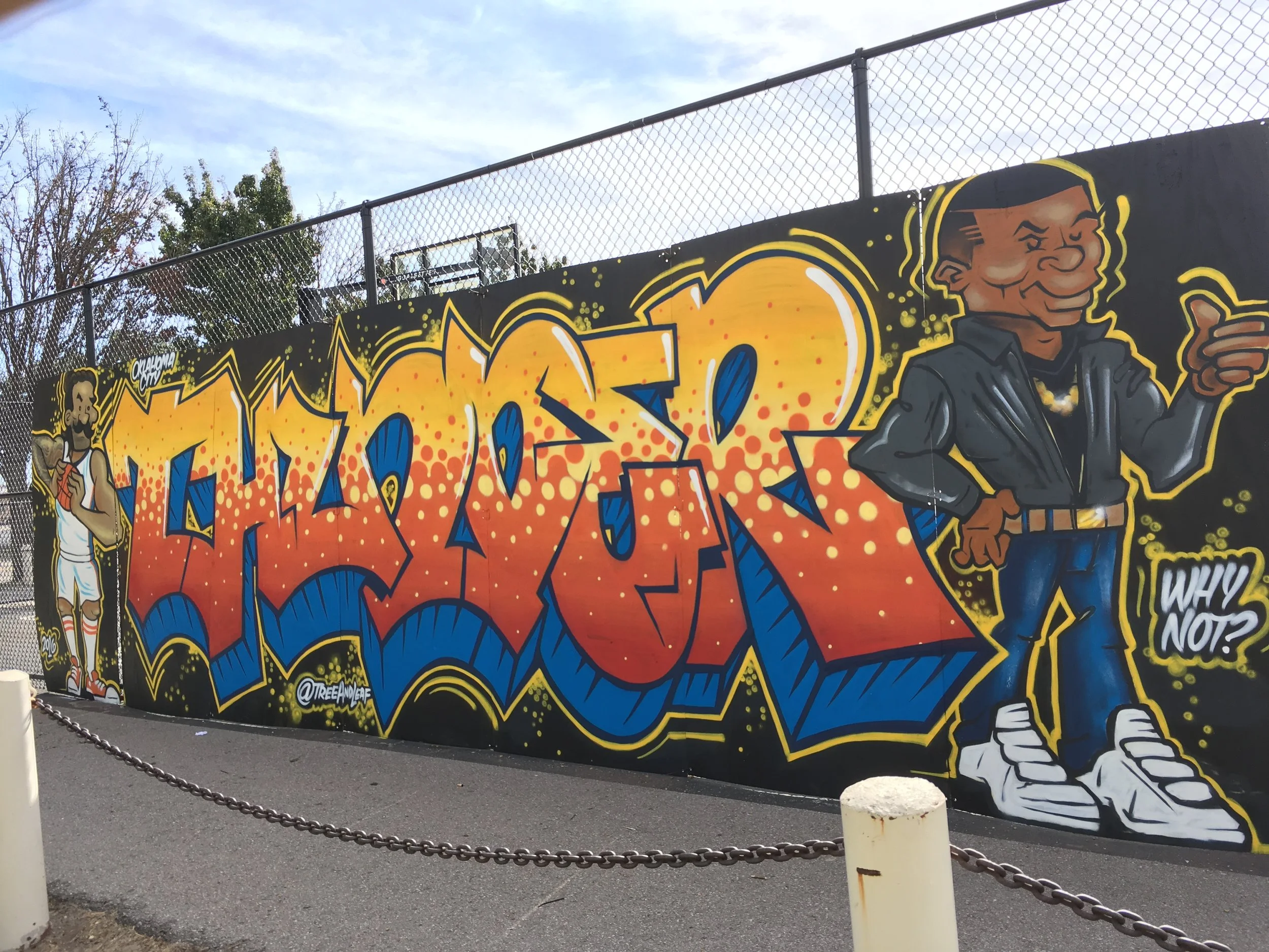 The mural is located on the corner of Hudson and Reno on the North side of the basketball courts. It is well lit at night and has a walkway right in front of it, perfect for taking some snapshots and selfies as you walk to Thunder home games!