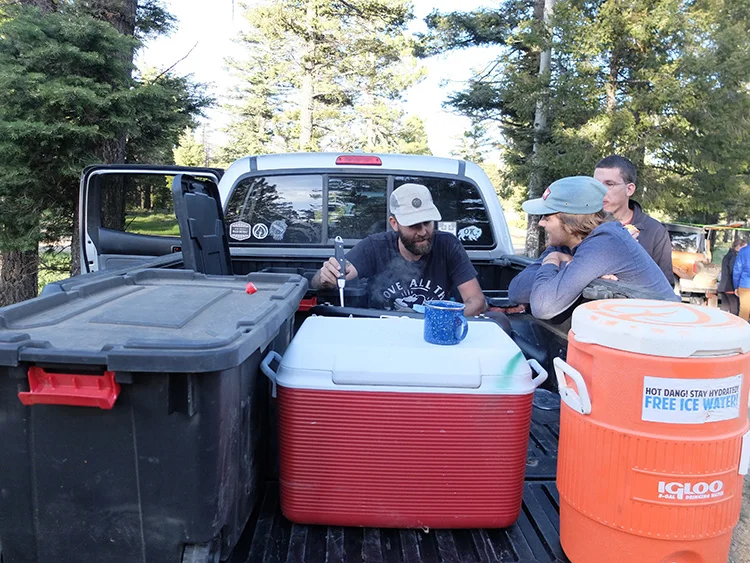 Cooking in the tailgate to help block the wind!