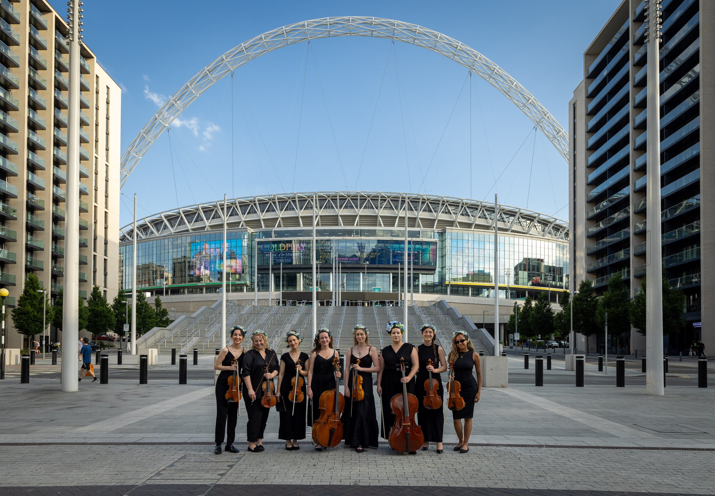 City String Ensemble performing as a string octet outside Wembley Stadium for the Wembley Park live string sessions during the Lana Del Rey, Taylor Swift, and Coldplay UK tours.