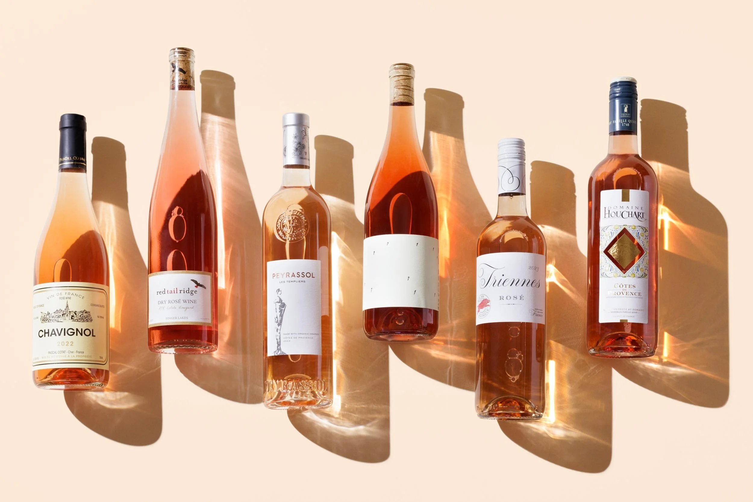 Bottles of rose on a pink backdrop photographed by Boston food and wine photographer Adam DeTour