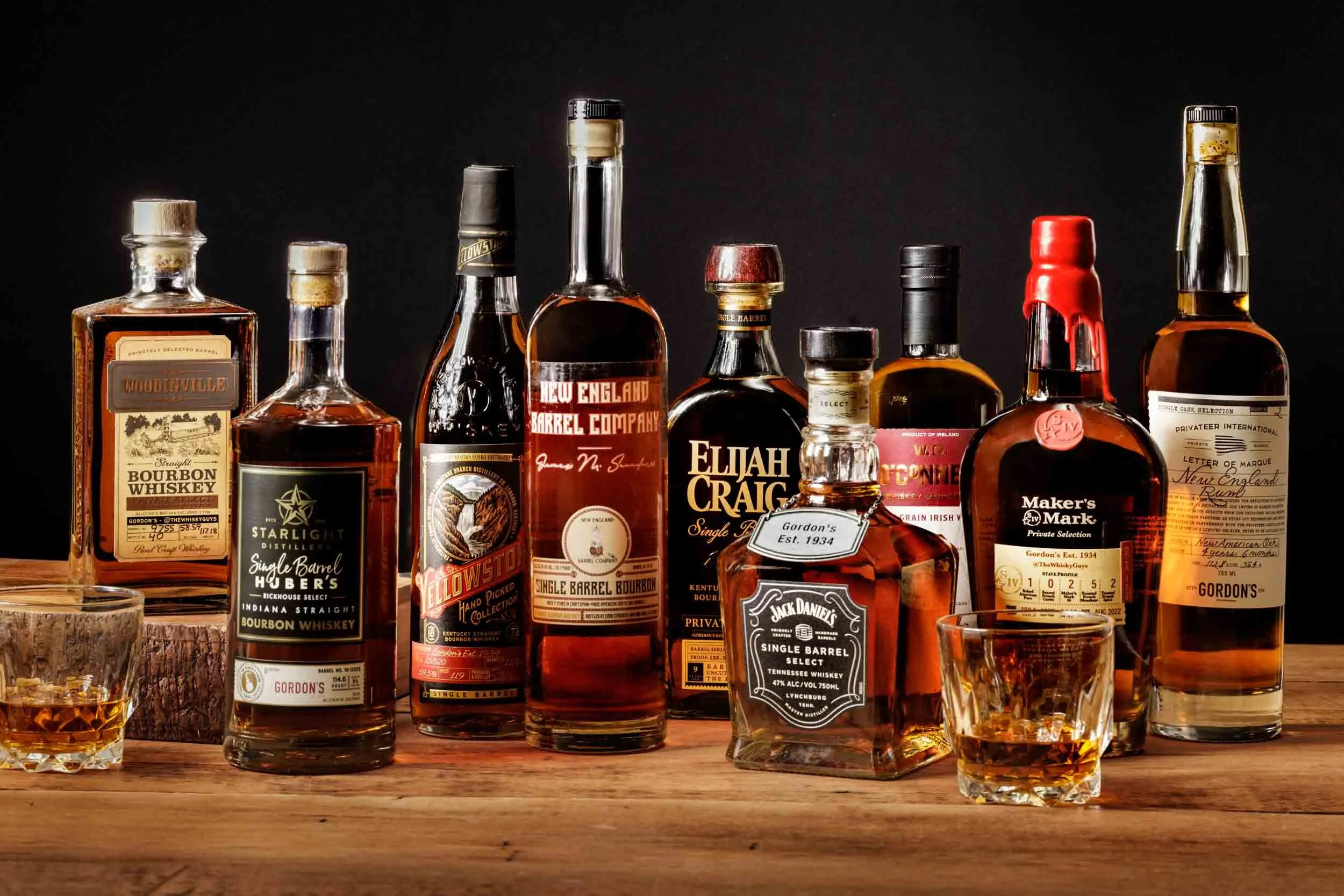 Bottles of Whiskey on a wood surface By Boston Drink Photographer Adam DeTour