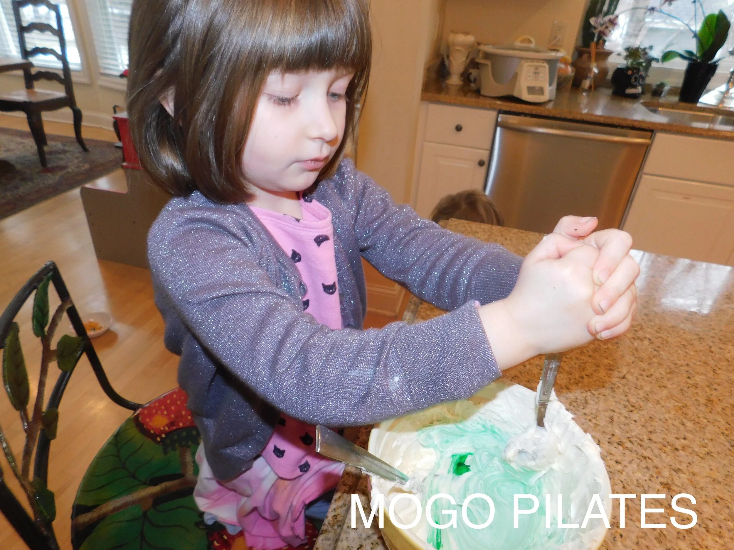 Iris was in charge of making the icing “magically” turn green!