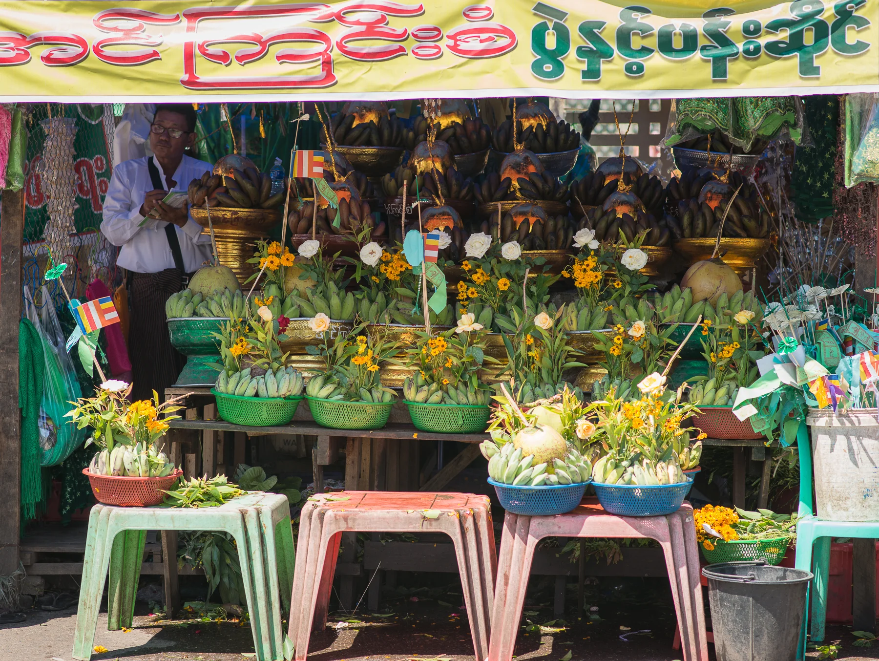 Offerings for Buddha for sale next to a Pagoda.  Yangon, Myanmar
