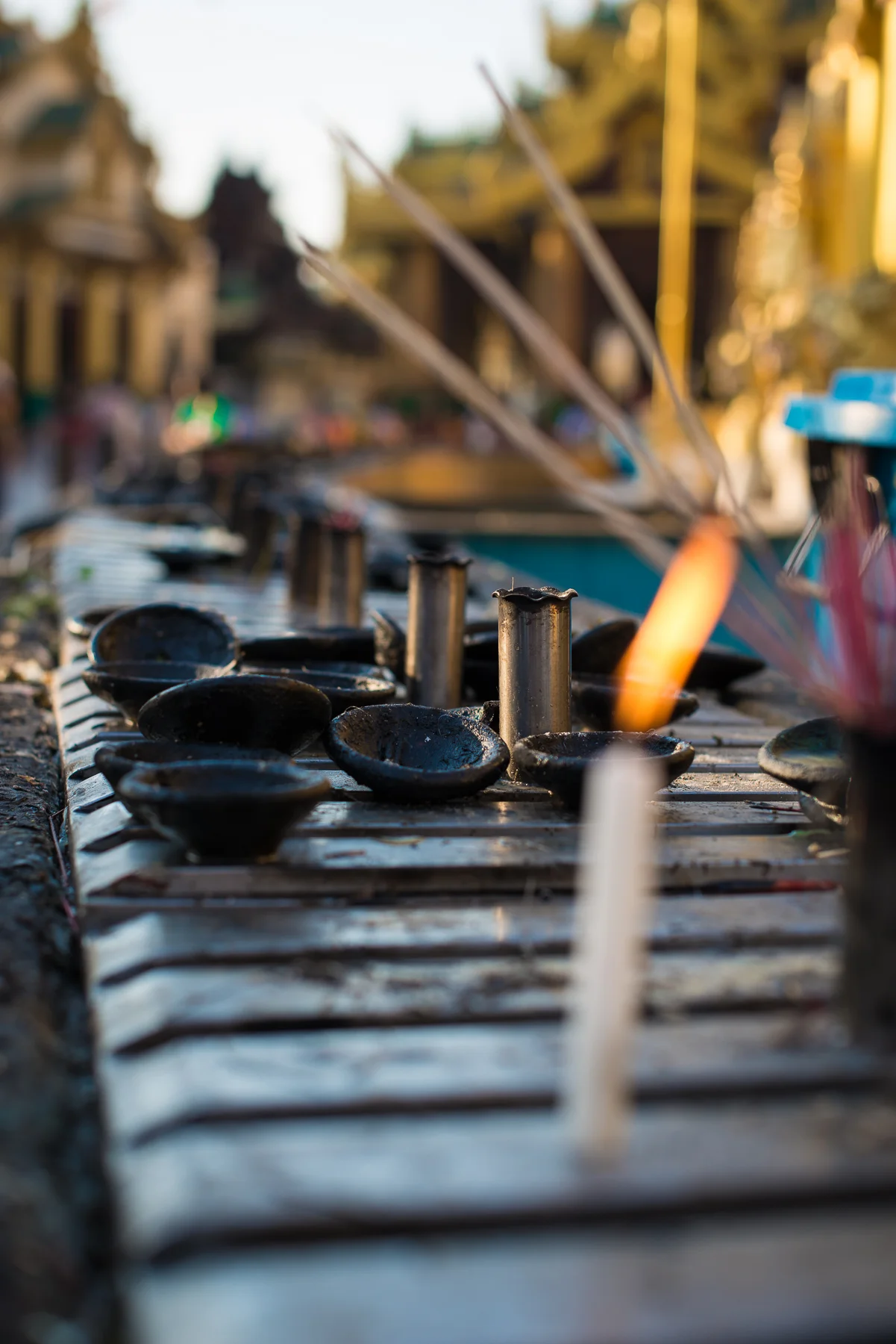 Candles, incense and oil lamps at Shwedagon Pagoda. Yangon, Myanmar