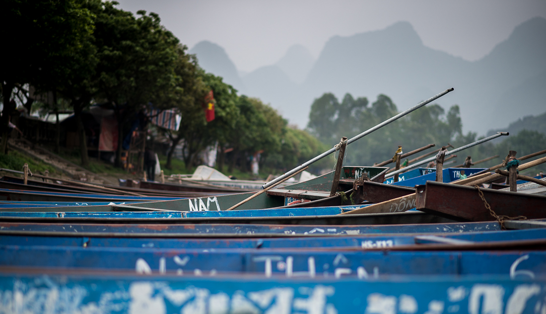Boats lined up on the river ready to take people to the Perfume Pagoda. Hanoi, Vietnam