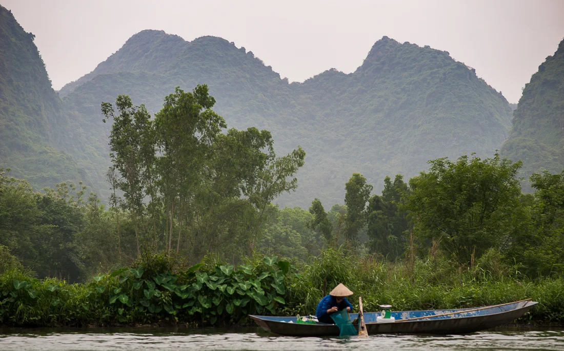 Fisherman on the river on the way to Perfume Pagoda. Hanoi, Vietnam