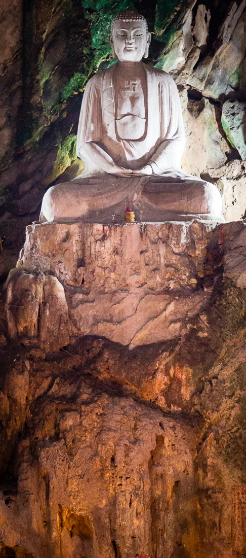 Giant Buddha in one of the caves on Marble Mountain. Hoi An, Vietnam