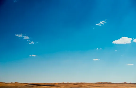 Red sand dunes in the distance. The desert road D707. So isolated.