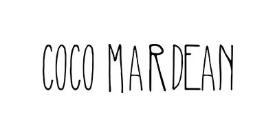 Text that reads 'COCO MARDEAN' in black, tall, handwritten-style letters on a white background.