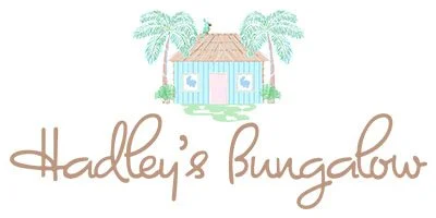 Illustration of a house with palm trees and water surrounding it, with the text "Hadley's Bungalow" underneath.