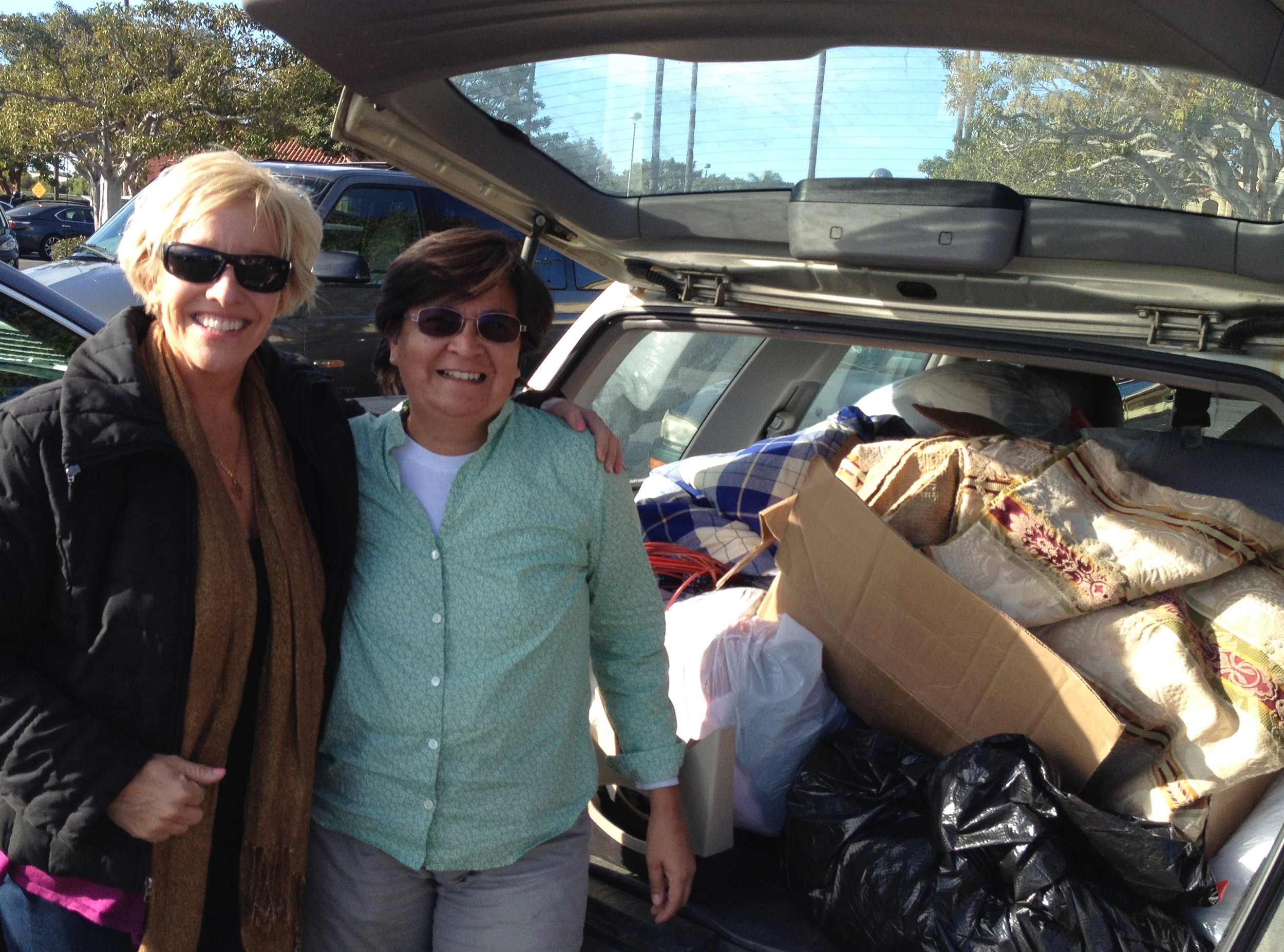Peggy Hall and Alicia Harvey loading up one of many carloads of generous donations of blankets, towels, sheets, pet beds, food, toys, leashes and medicine bound for Mexico