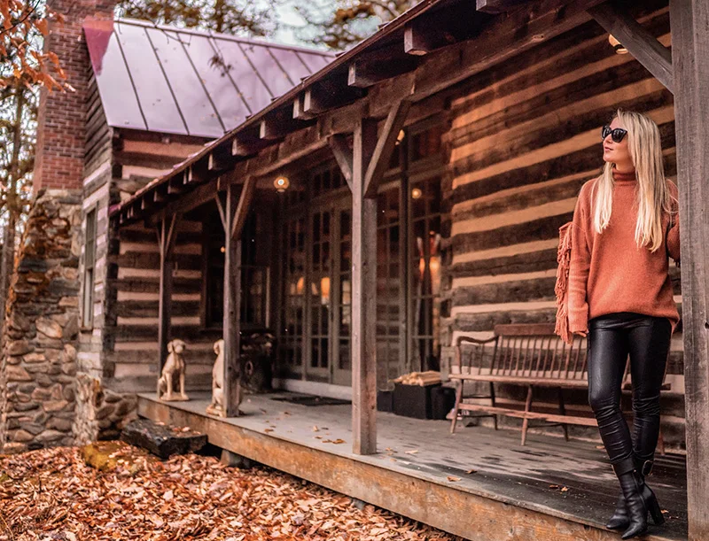 christie ferrari wears fall and winter staple centric look with copper oversized sweater and black faux leather leggings with black boots in Vermont.