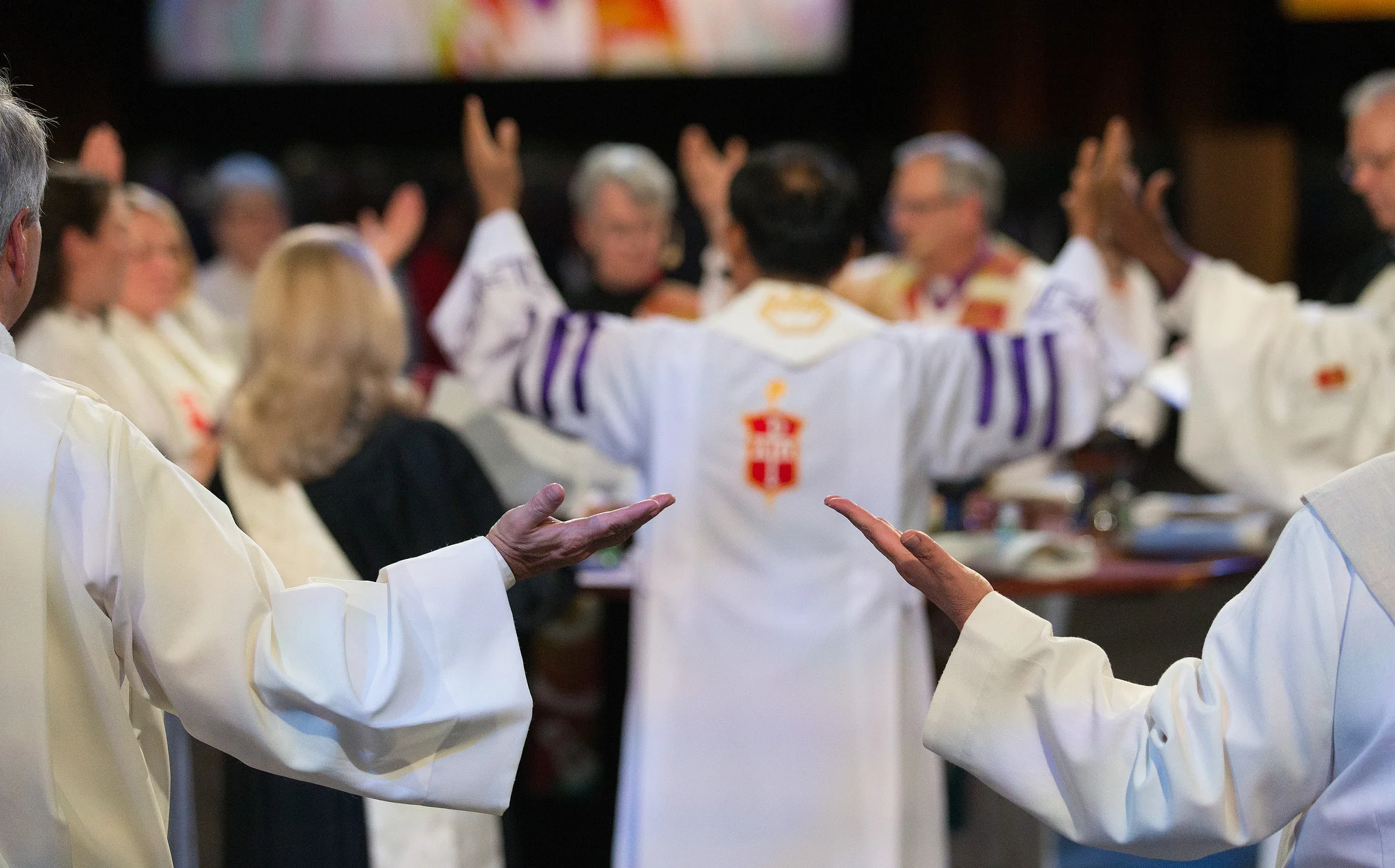 Clergy help to bless the elements for Holy Communion. Photo credit: Mike DuBose, UMNS