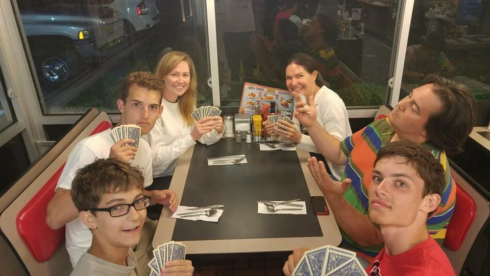 Stewart (second from right) playing a late night game of cards with a late night meal at Waffle House on the Youth Mission Trip to Tennessee this summer.