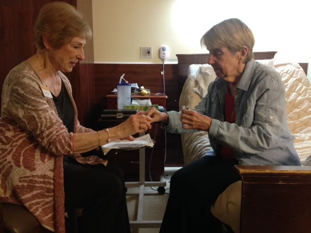 Carolyn (left) and Linda (right) serving communion to one another.