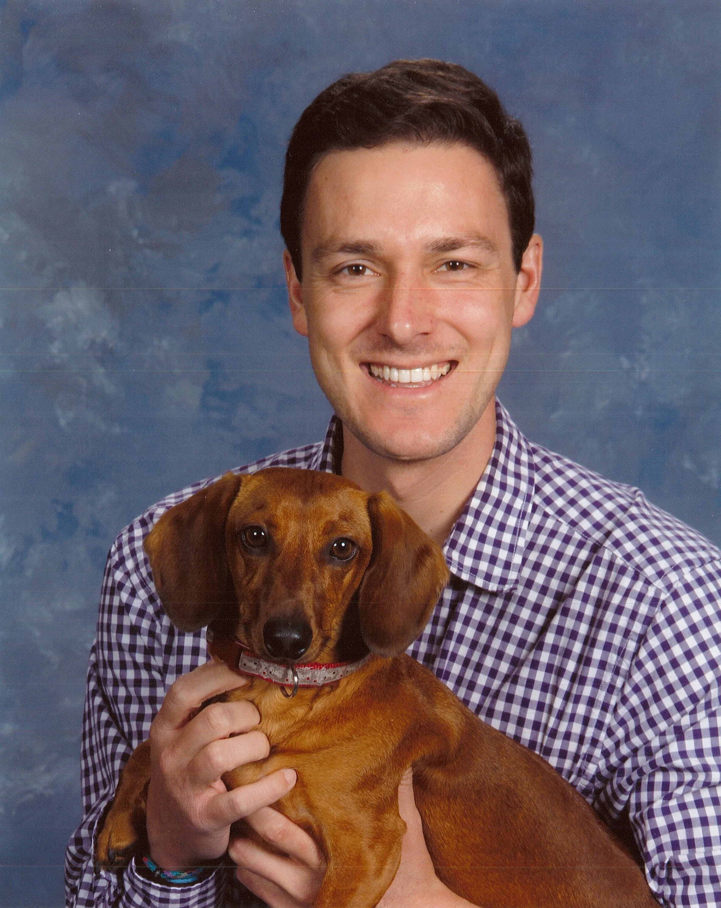A silly protest of the required church directory photo by including his pastor's dog