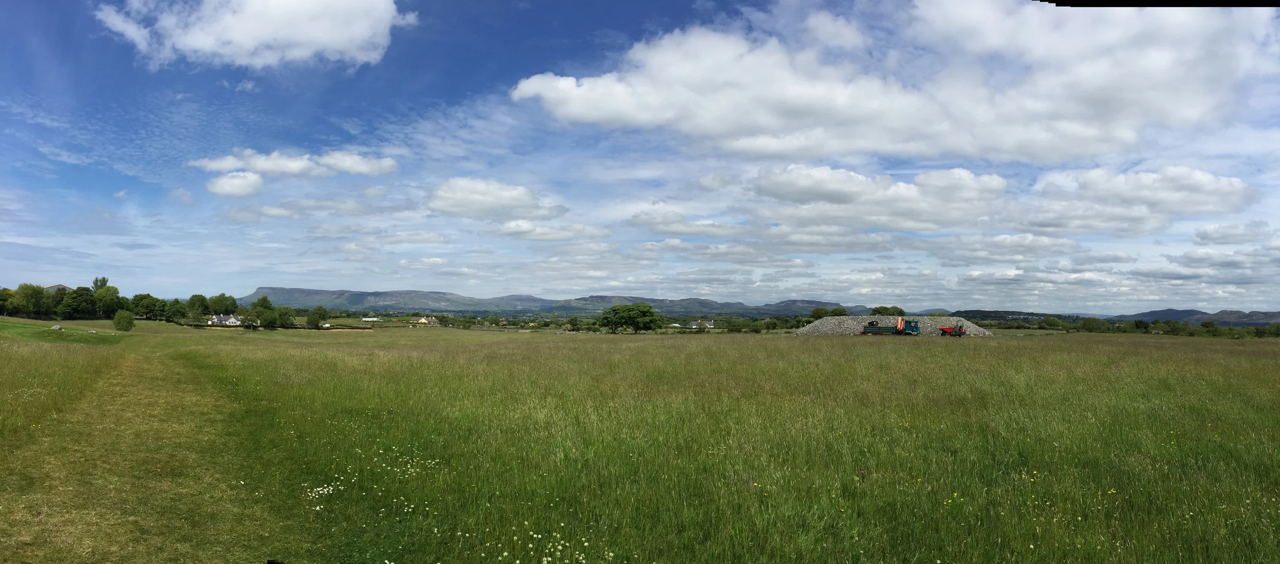 Again, in the middle of a field, like Hill of Tara, mountains dotting the distance.